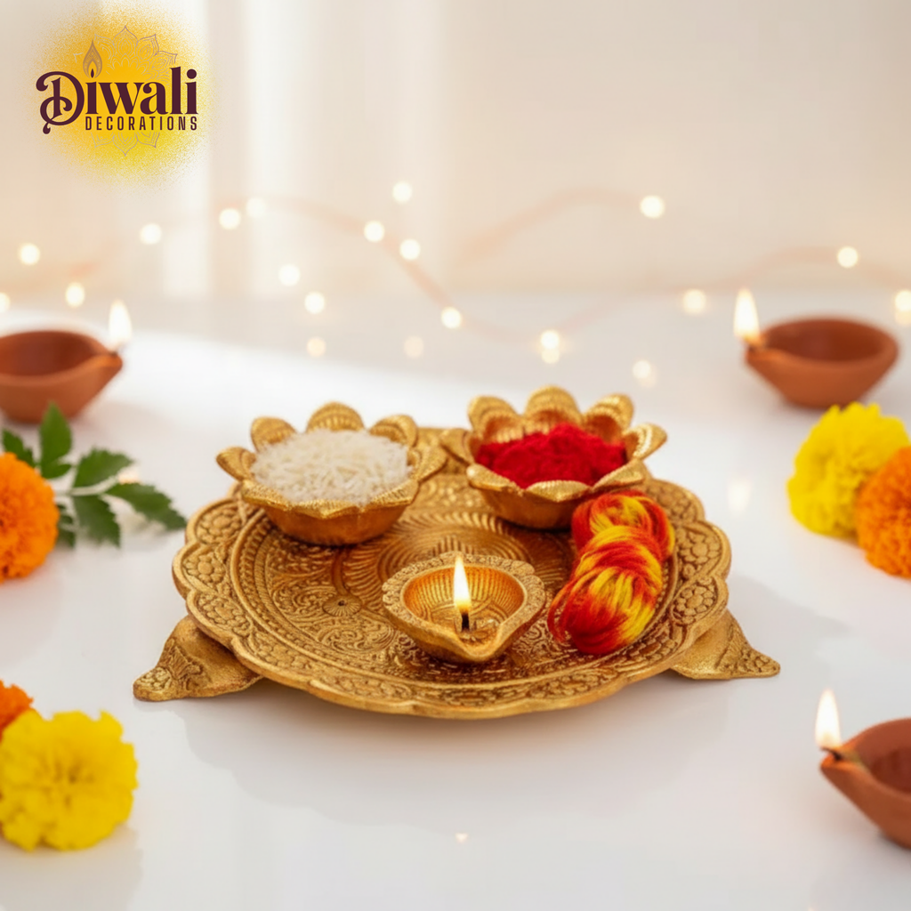 Decorative setup for Diwali with gold tray, lit candle, and flowers on a white background.
