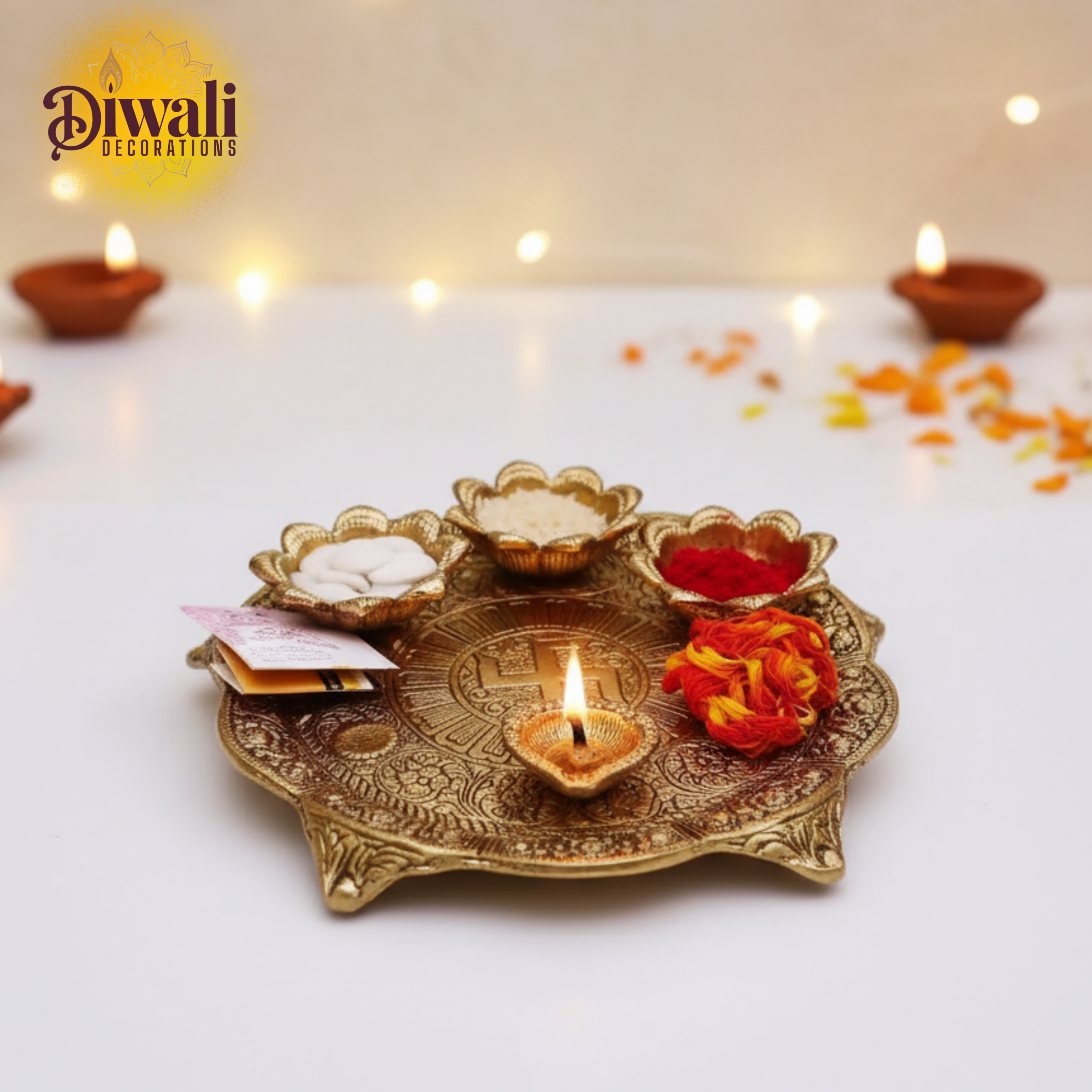 Decorative Diwali setup with lit candles, flowers, and a decorative plate on a white background.