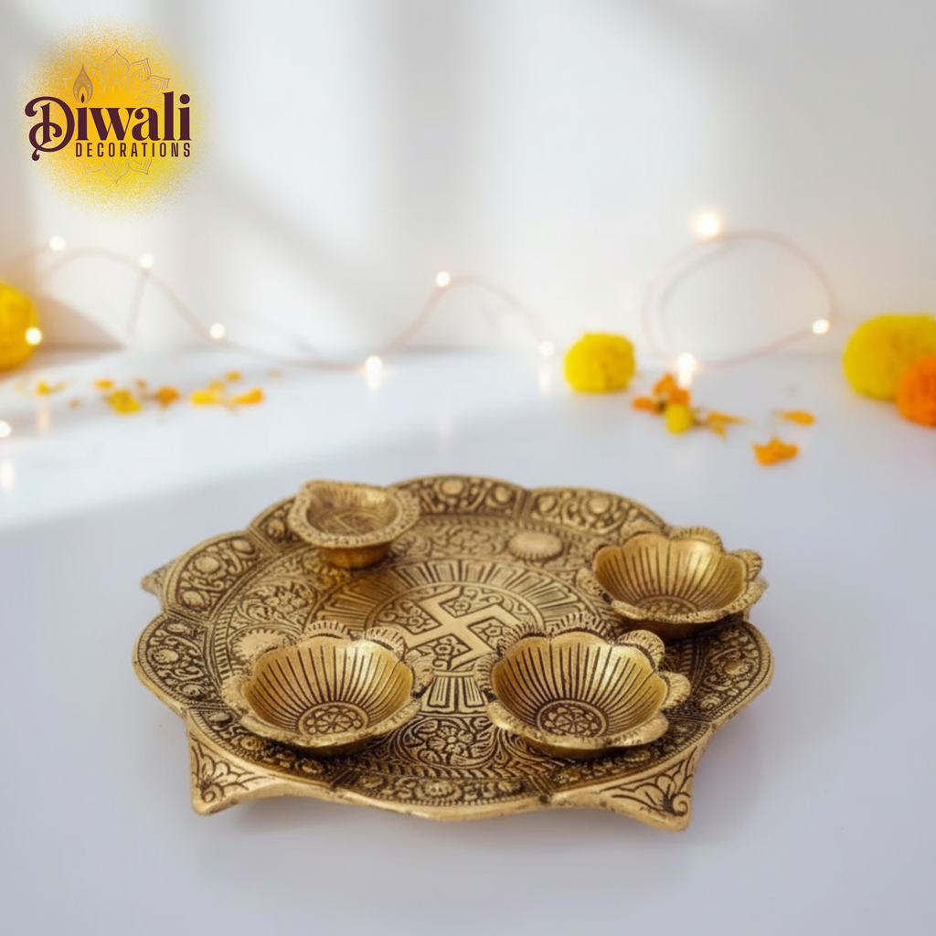 Decorative gold tray with small bowls on a white background with Diwali decorations.