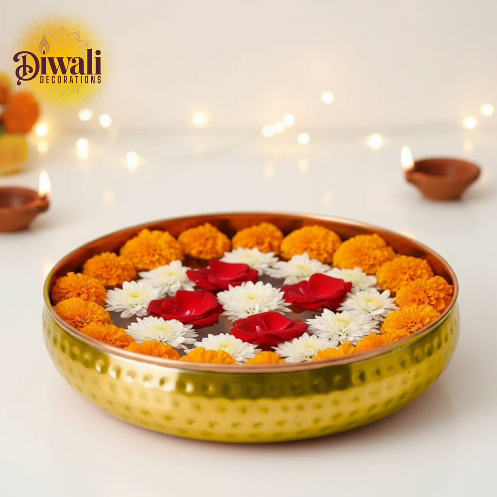 Decorative floral arrangement in a gold tray with Diwali decorations in the background