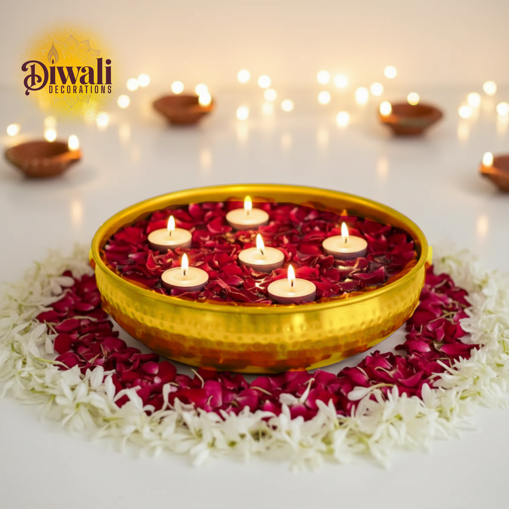 Decorative Diwali setup with a yellow bowl containing floating candles on red petals, surrounded by white flowers and string lights.