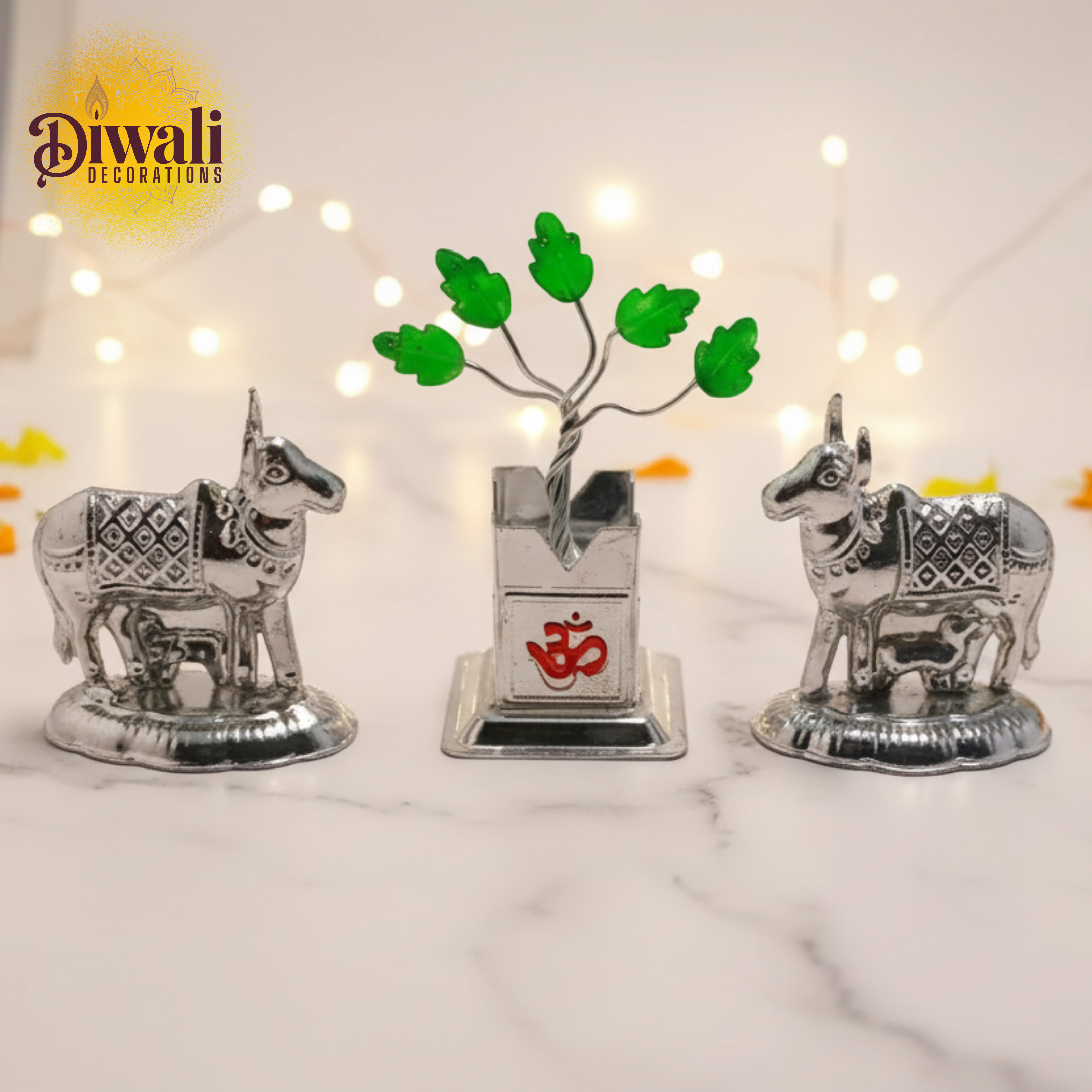 Decorative items with cows and a tulsi plant on a marble surface, featuring 'Diwali Decorations' text.