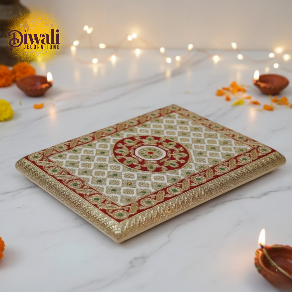 Decorative tray with Diwali decorations on a white surface with lights and candles.