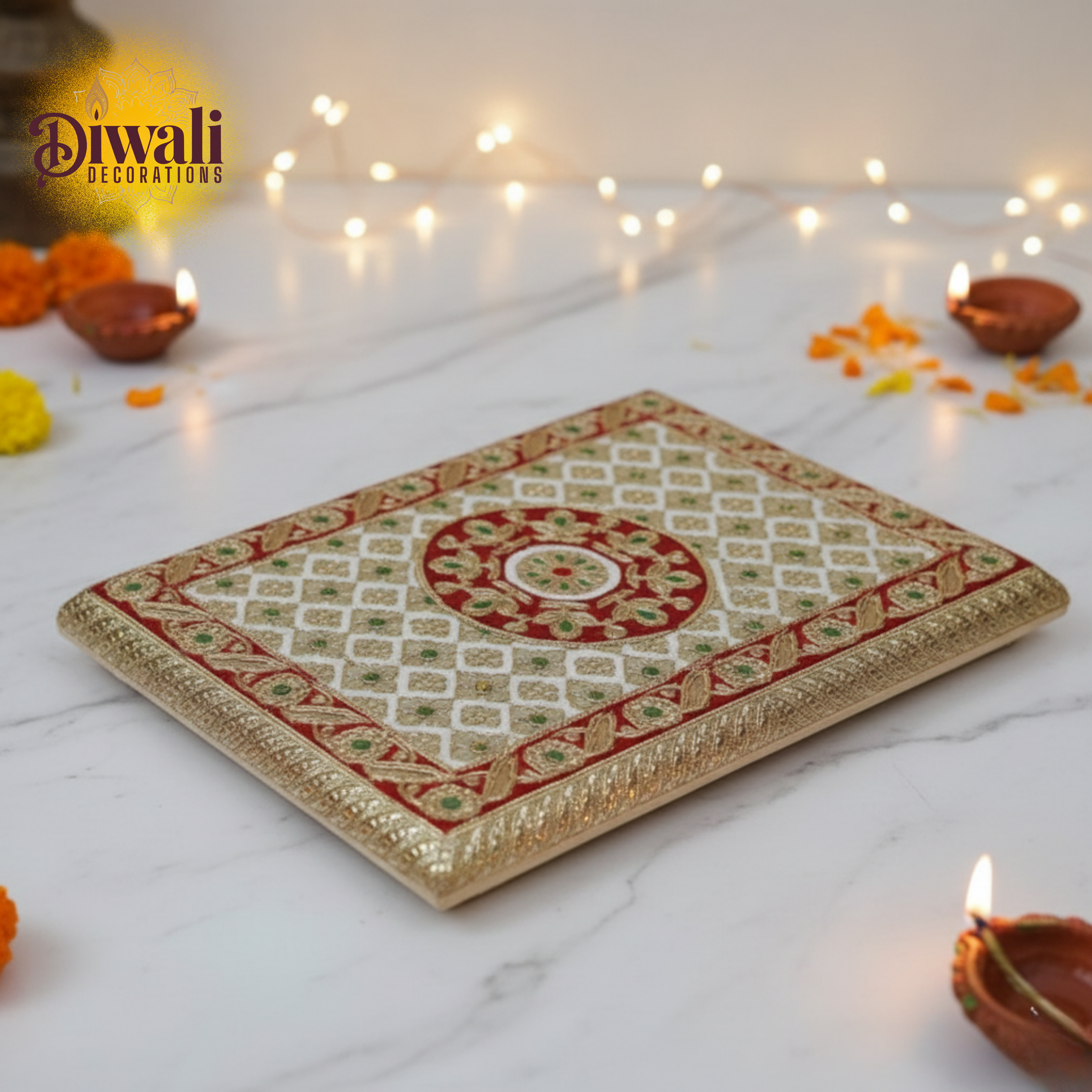 Decorative tray with Diwali decorations on a white surface with lights and candles.
