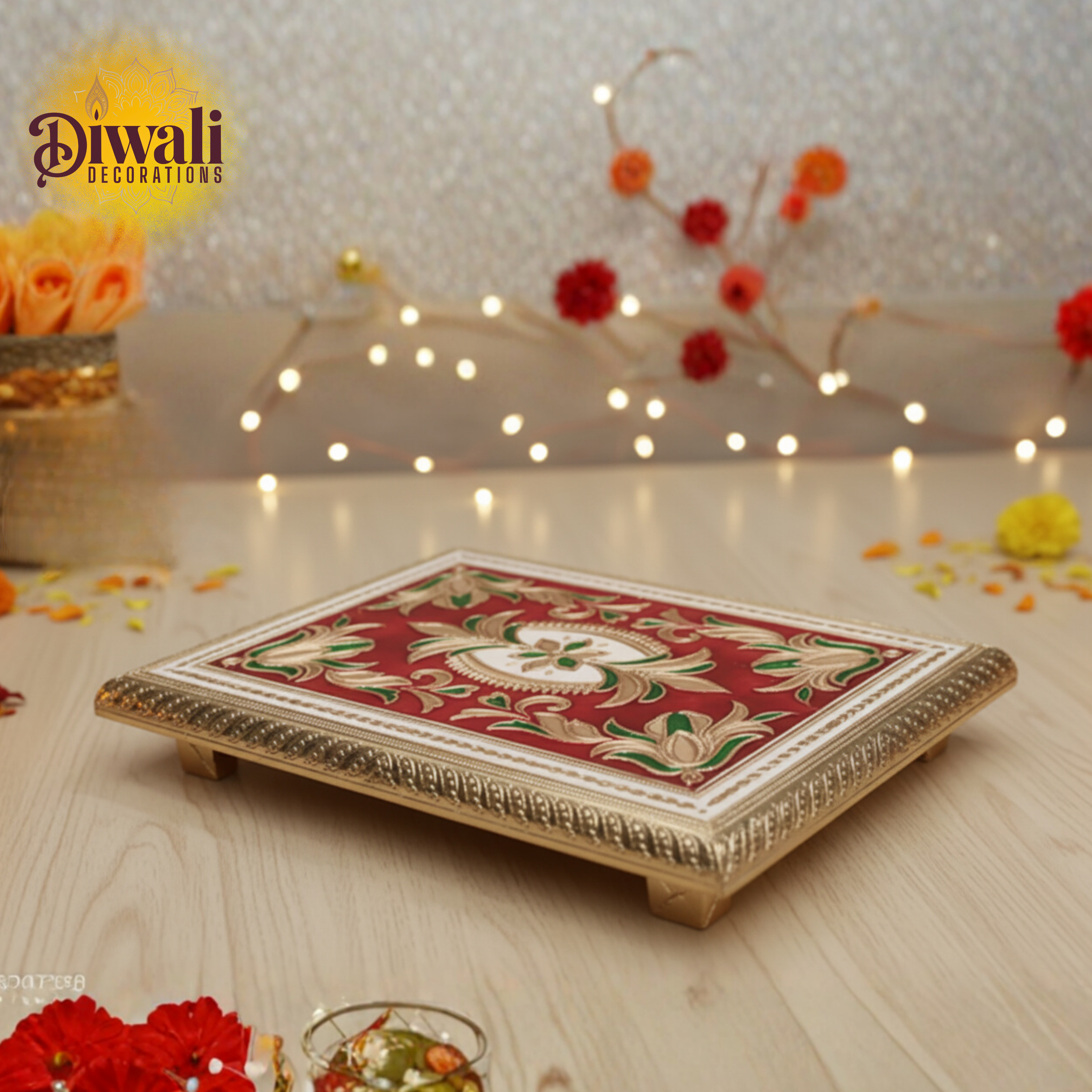 Decorative tray with floral patterns on a wooden surface with Diwali decorations.