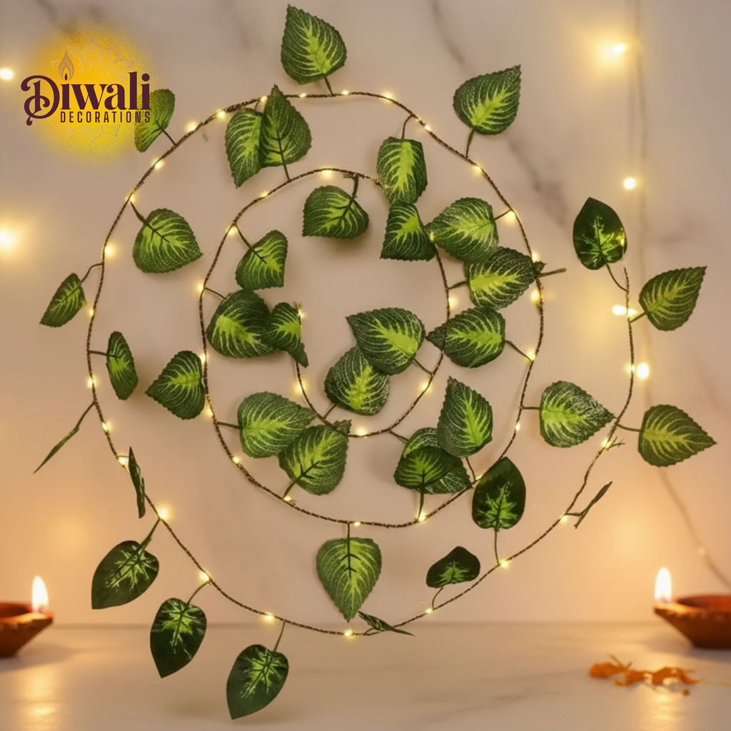 Decorative wall art with green leaves and string lights on a Diwali theme.